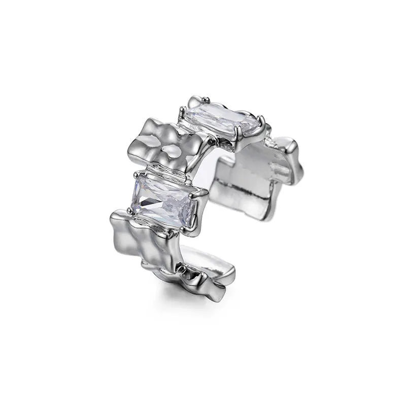 Silver plated open ring with a cross design and zircon gemstones in a geometric shape.