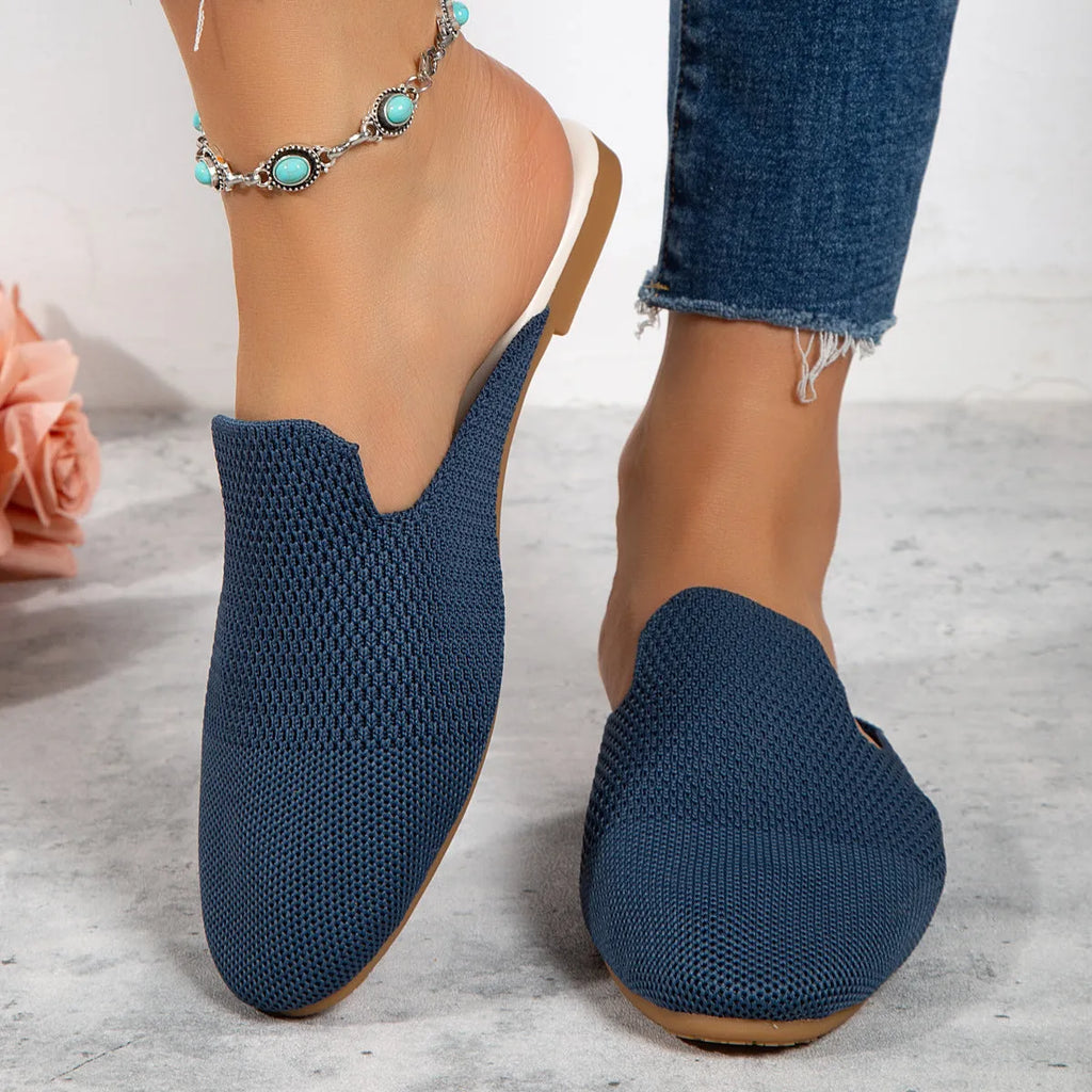 Apricot coloured mesh slip-on sandals with round toe, cloth upper, and flat rubber sole.