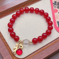 A red agate bracelet for women with a manual crafted dragon design in Chinese style.