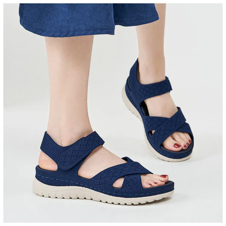 Plus size flat sandals in apricot with Flyknit upper, PVC sole, and Velcro strap.