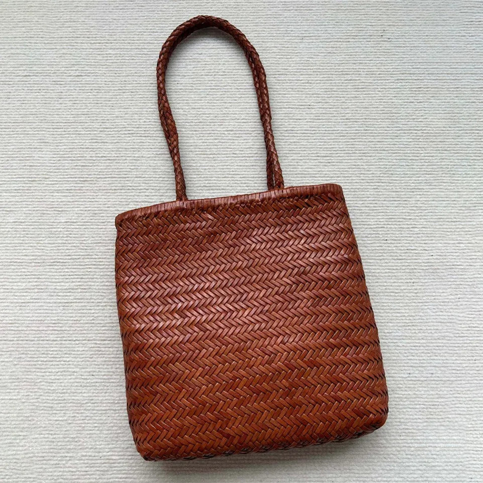 Woven vintage cowhide leather tote bag with three-dimensional outer pockets showing brown colour