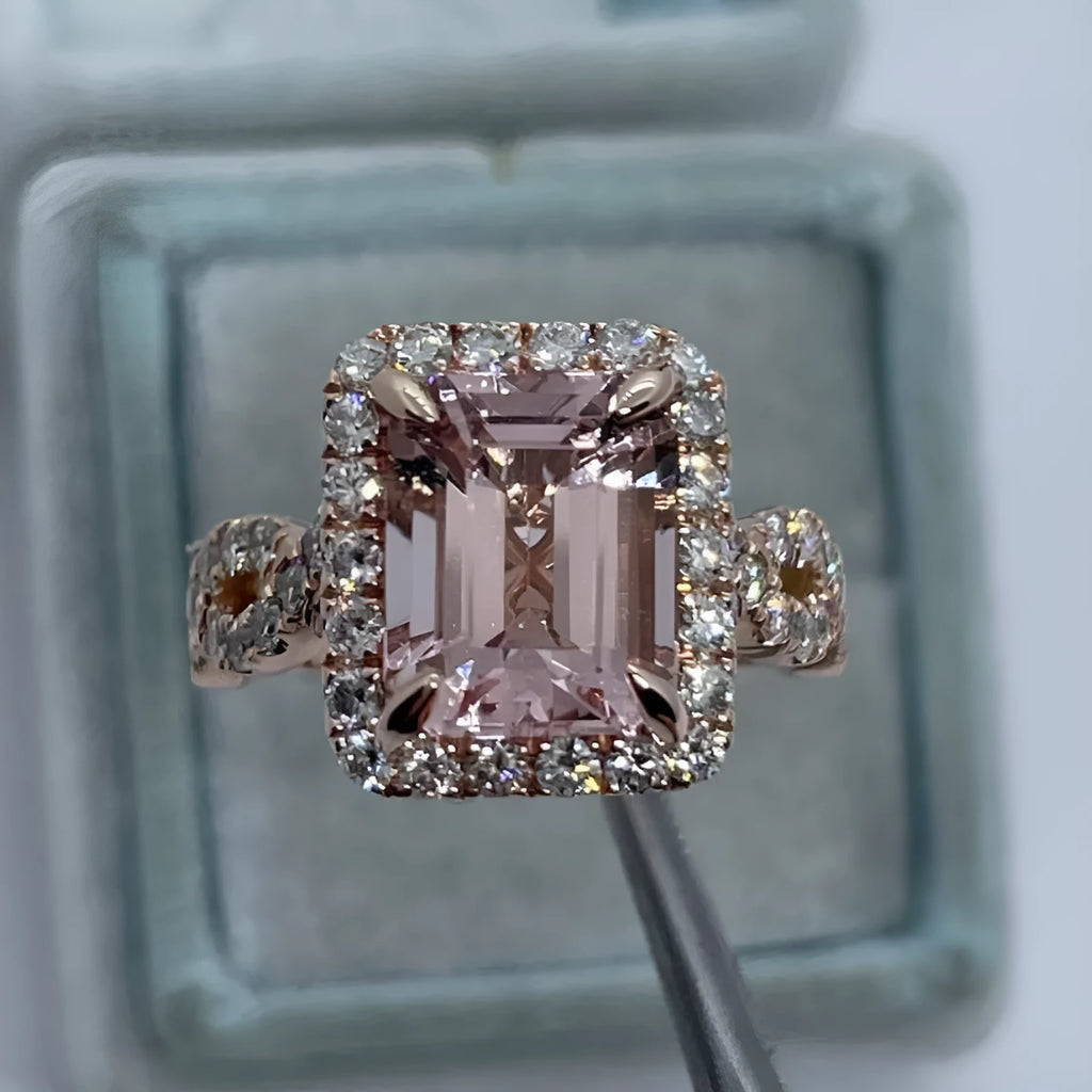 Geometric rose gold alloy ring on a plain background, showing its angular shape and metallic finish.