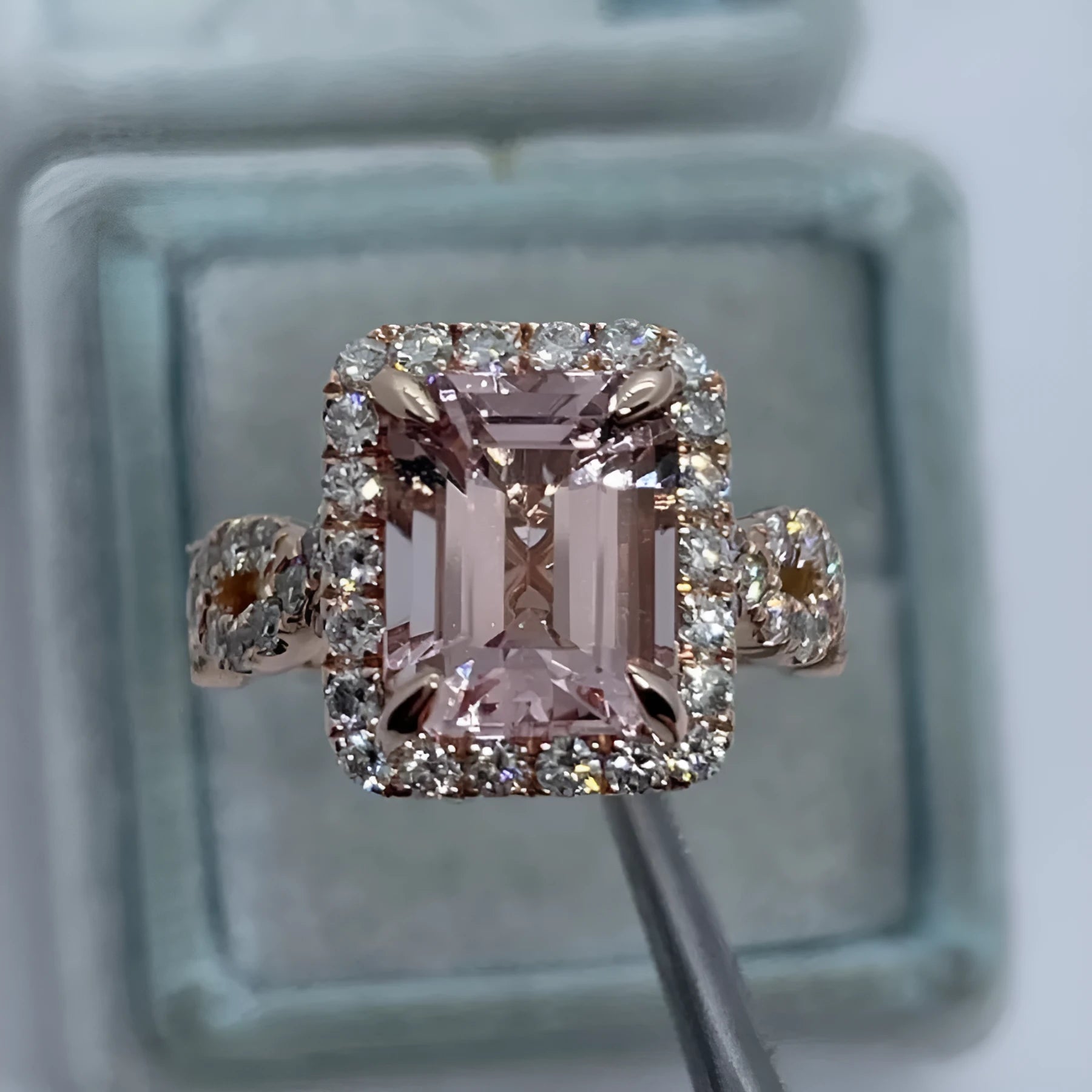 Geometric rose gold alloy ring on a plain background, showing its angular shape and metallic finish.