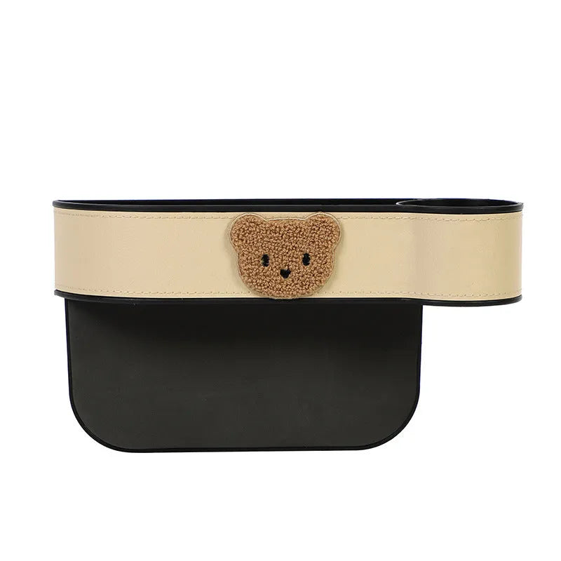 Leather car seat gap storage box with cartoon bear design, shown fitted next to a car seat.