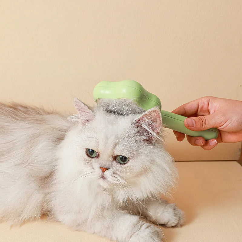 Magic wand cat comb with stainless steel needle teeth and self-cleaning mechanism in green colour