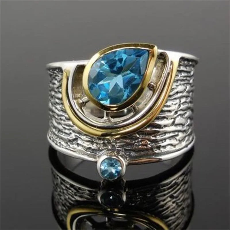 Close-up of a blue zircon and rhinestone drop-shaped ring in a Chinese style design.