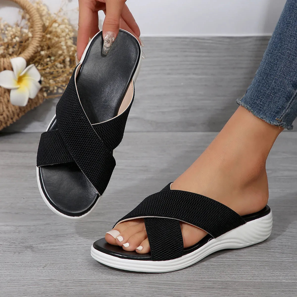 Women's black wedge peep-toe slippers with a thick rubber sole on a white background.