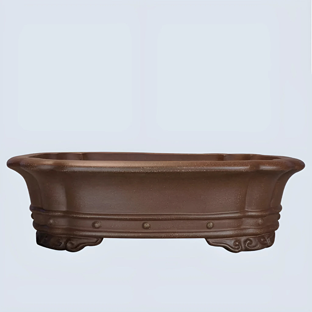 Handmade antique purple sand rectangular begonia flower pot on a desktop.