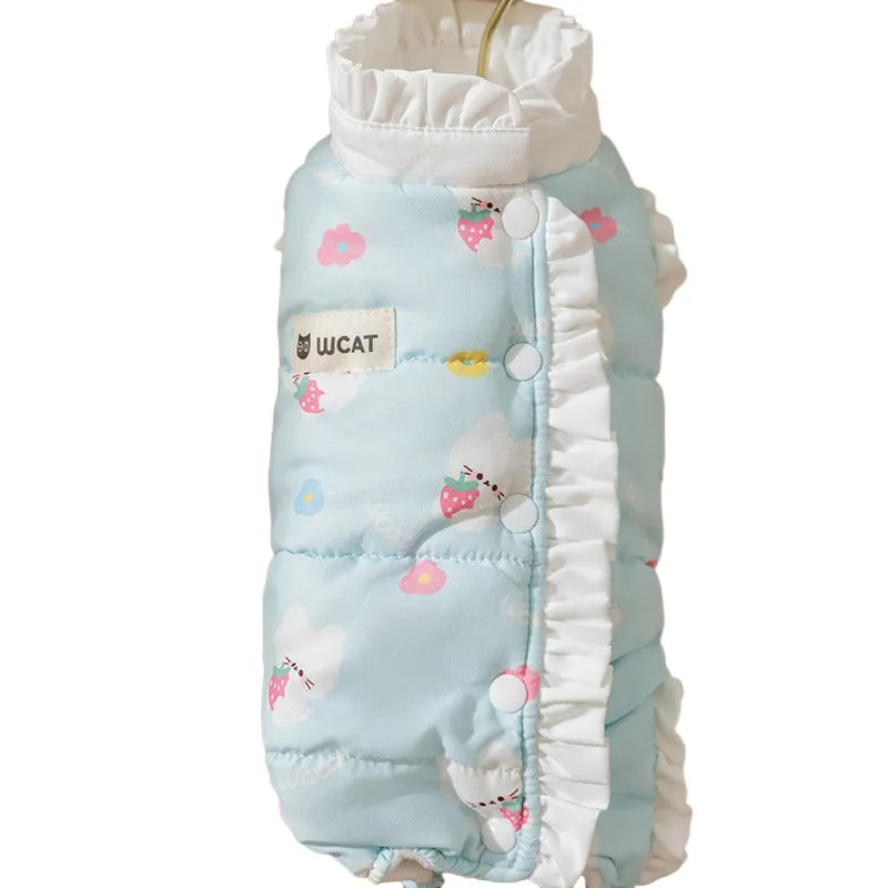 Small dog wearing cream fleece jumpsuit with bear pattern and white ruffles