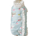 Small dog wearing cream fleece jumpsuit with bear pattern and white ruffles