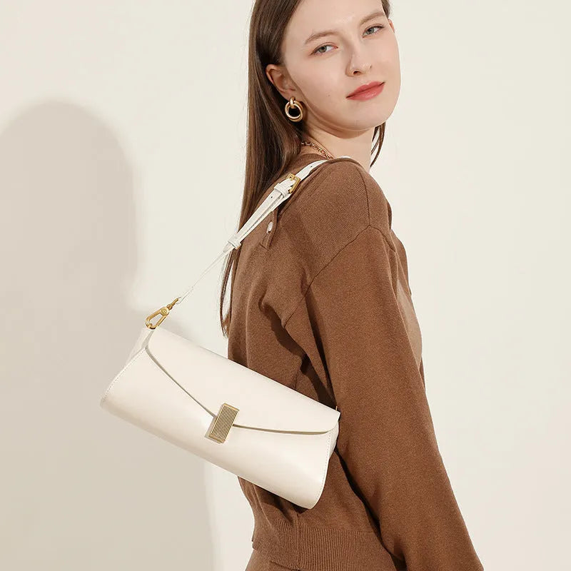 Milky white cowhide leather women's cross-body bag with pillow shape and cross-body strap.