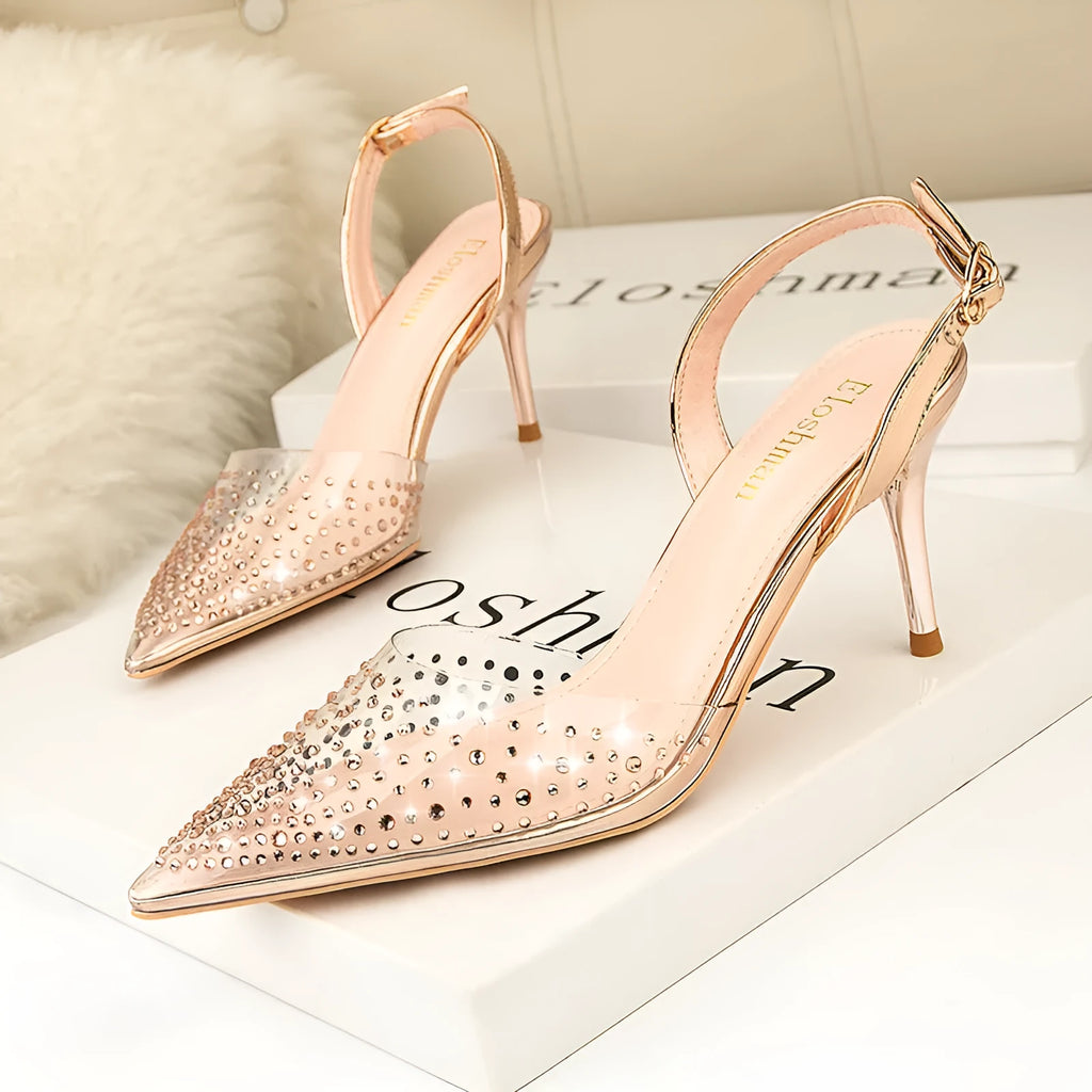 Women's black pointed low-cut stiletto high heels with buckle closure on a light background