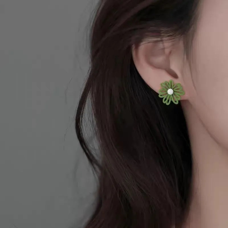 Cartoon flower earrings in alloy with blue and orange, white and green, or yellow and white two-tone colours