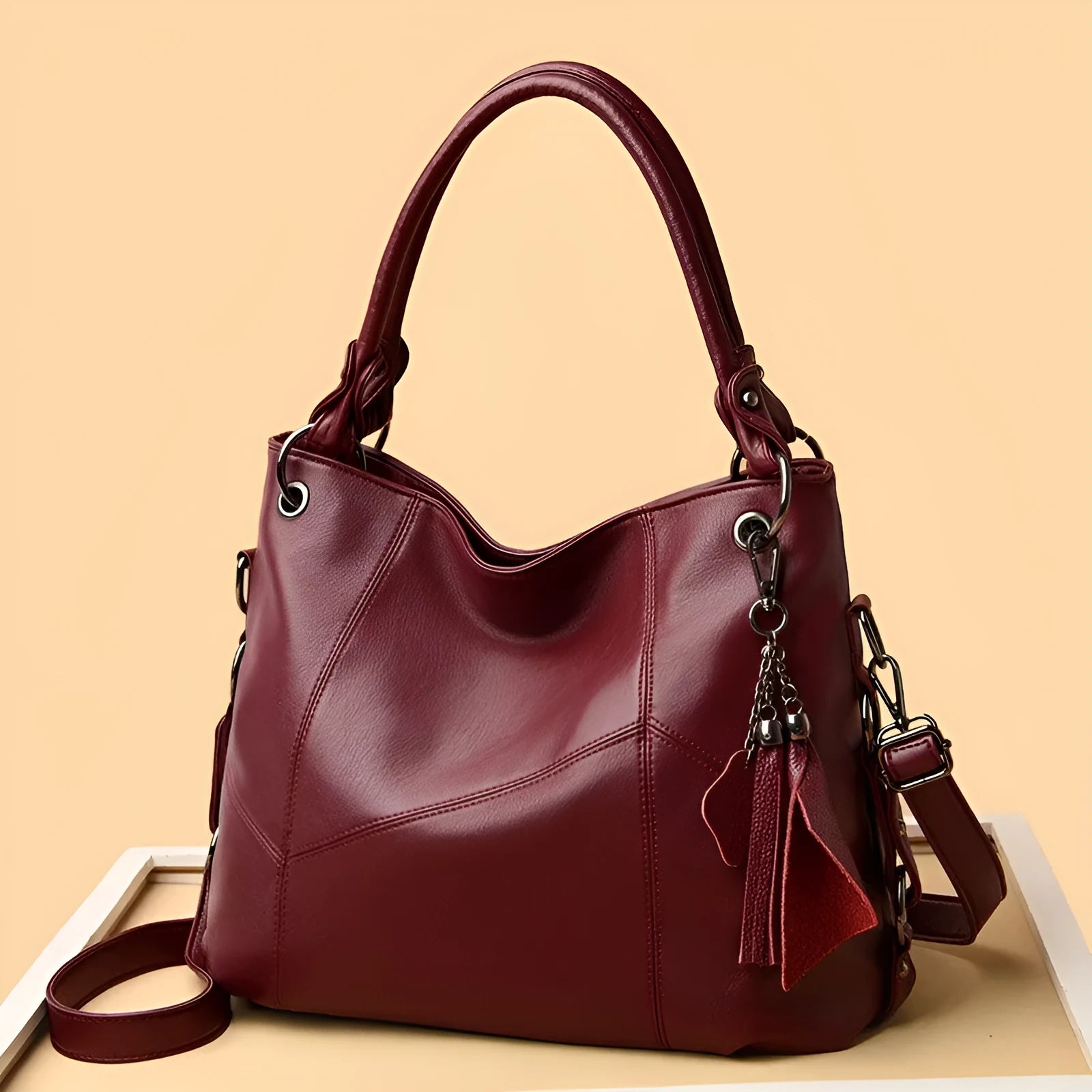 Large capacity PU tassel handbag in black, front view with tassel detail