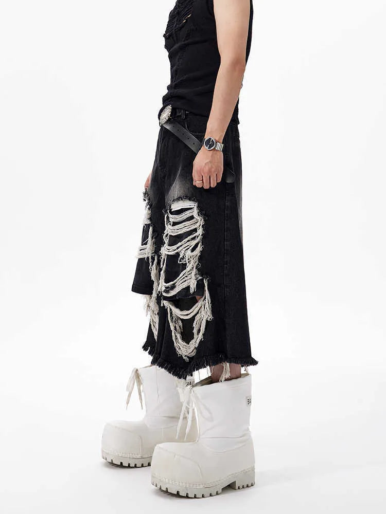 Black wide-leg cropped jeans with ripped patch details on a mid-high waist, loose fit.