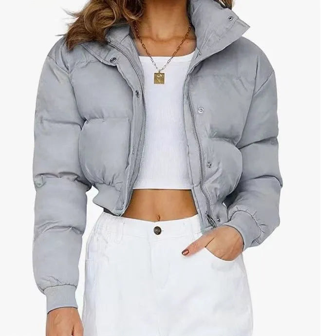 A woman's loose-fitting long-sleeve polyester jacket in blue, shown on a hanger.