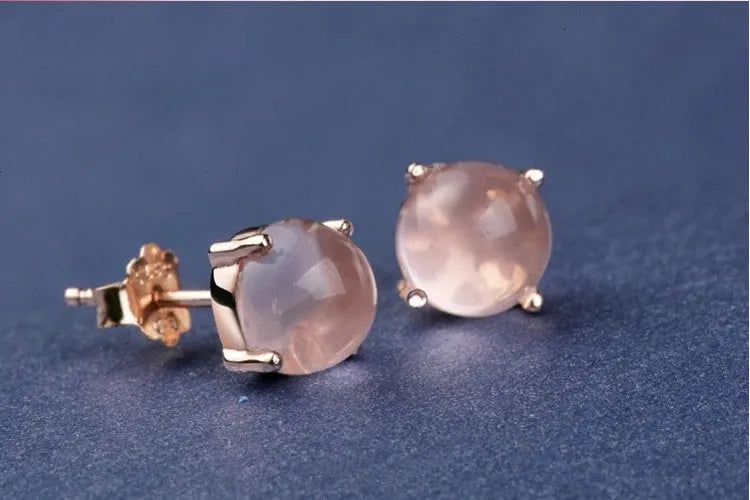 Women's rose gold plated stud earrings with a drop-shaped synthetic rose quartz stone.