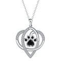 Women's copper necklace with dog and cat paw print pendant on cross chain.