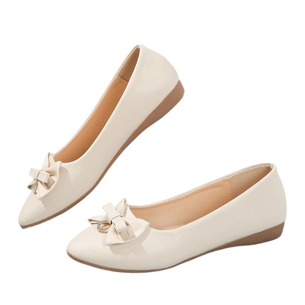 Women's beige flat casual shoes with a bowknot and shallow mouth design on a white background.