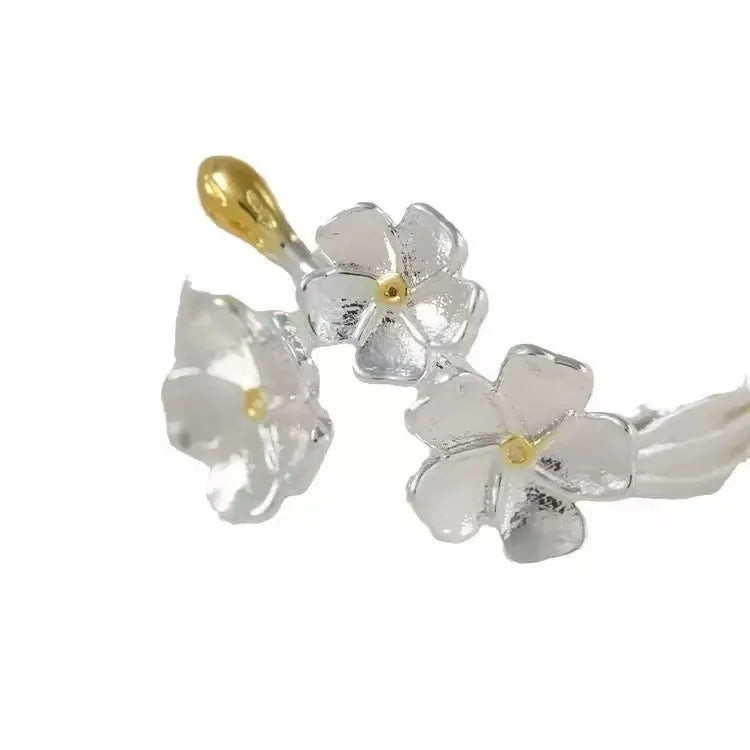 3D jasmine flower adjustable ring in zinc alloy with electroplated finish on a hand.