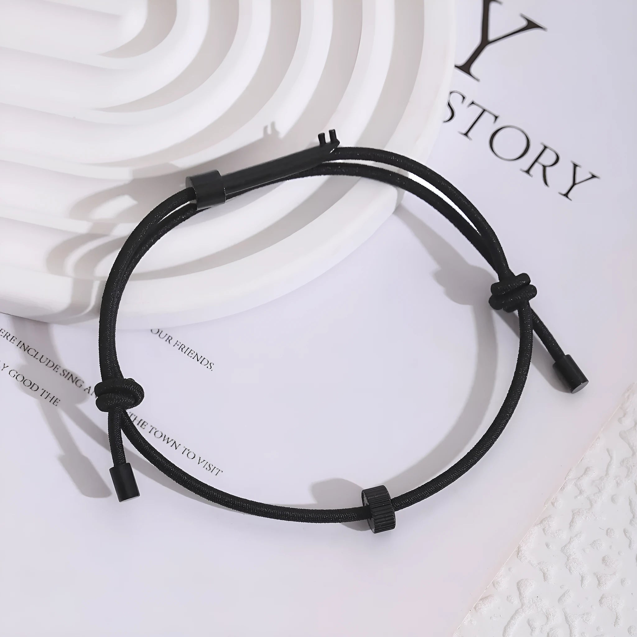 Tungsten carbide adjustable emergency escape bracelet with window breaker tip on grey background