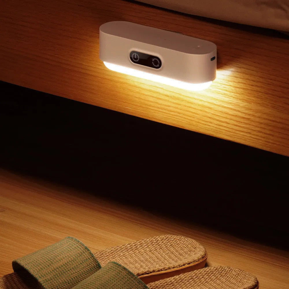 White magnetic USB rechargeable LED night light with touch controls and a curved light surface.