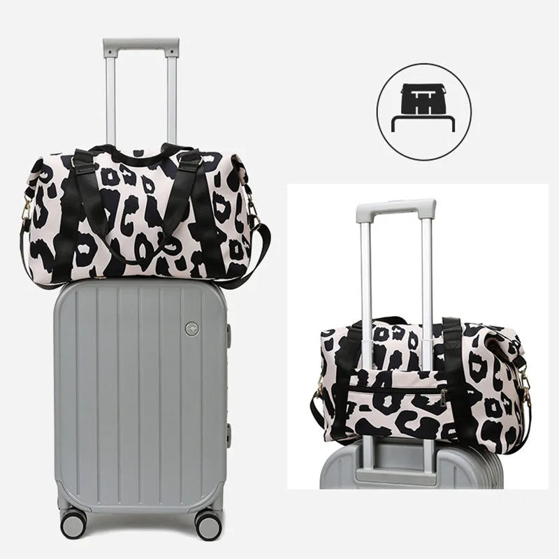 Women's large travel duffel bag with cow pattern, black, showing zippered main compartment and soft handle