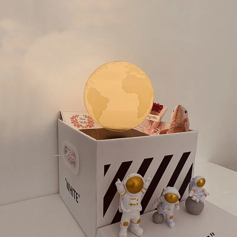 Maglev floating planet night light with three astronaut figurines and USB cable
