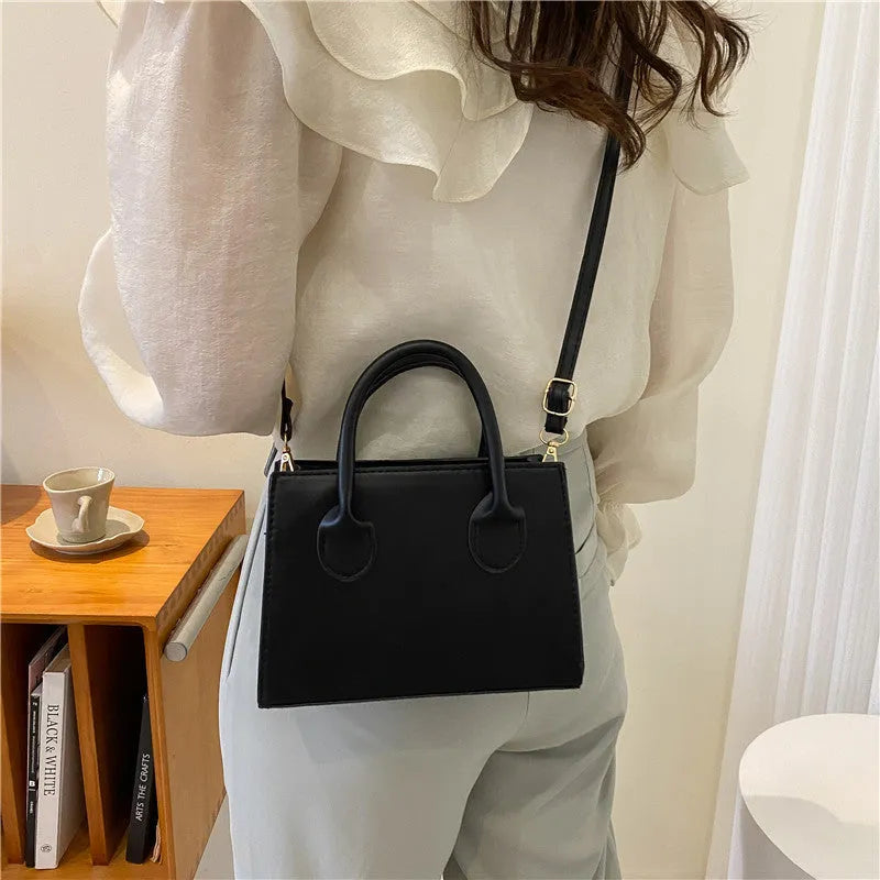 PU synthetic leather small horizontal square shoulder bag in five colour options showing document pocket and single strap