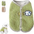 Green coral fleece dog vest with leash ring on a small dog, showing winter outfit.