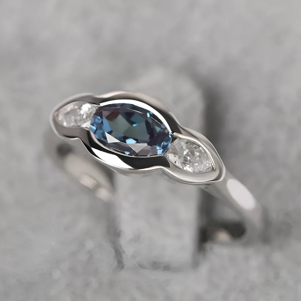 Women's geometric ellipse ring with inlaid zircon stone in white gold colour, shown on a hand.