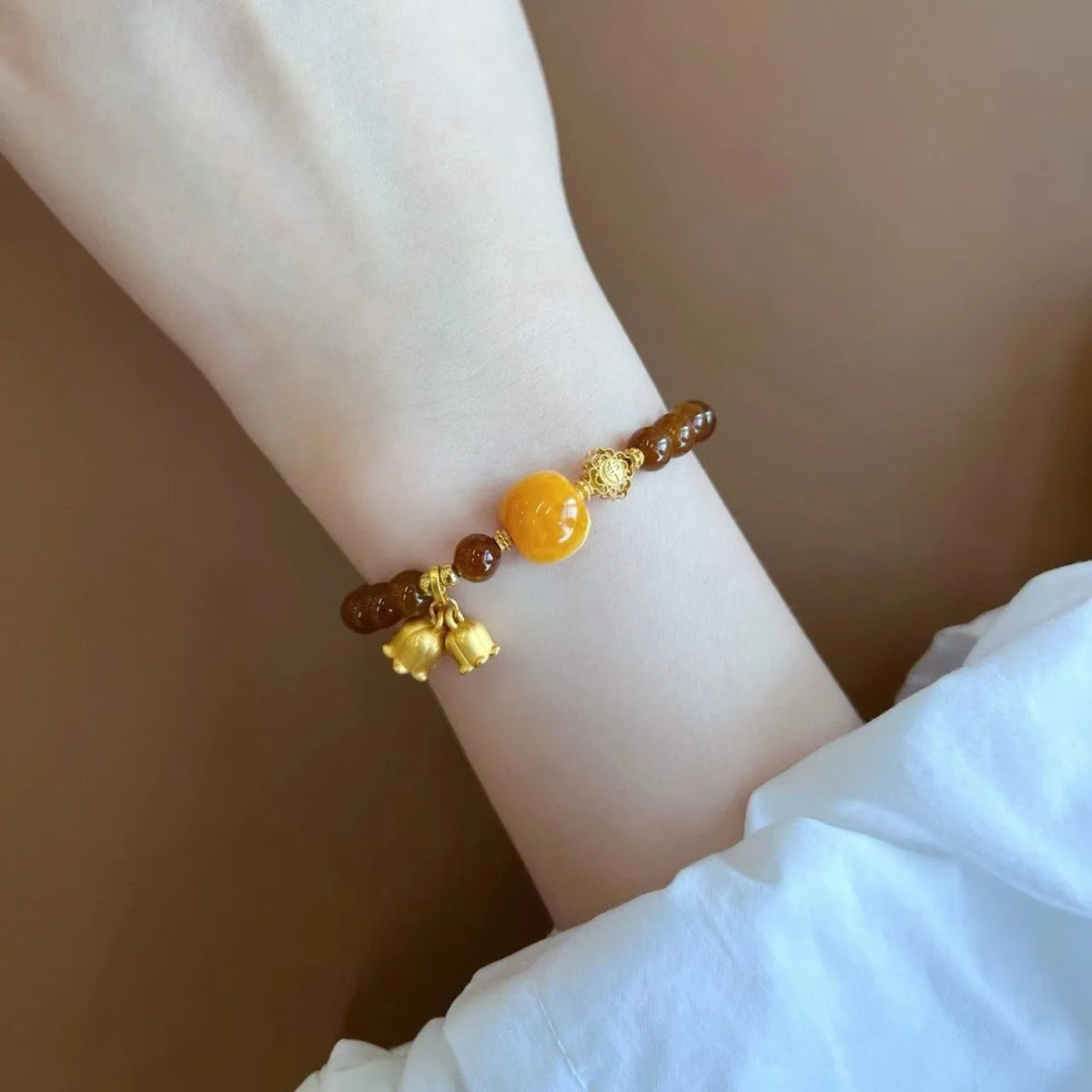Caramel beeswax Lily bracelet with electroplated finish and floral design