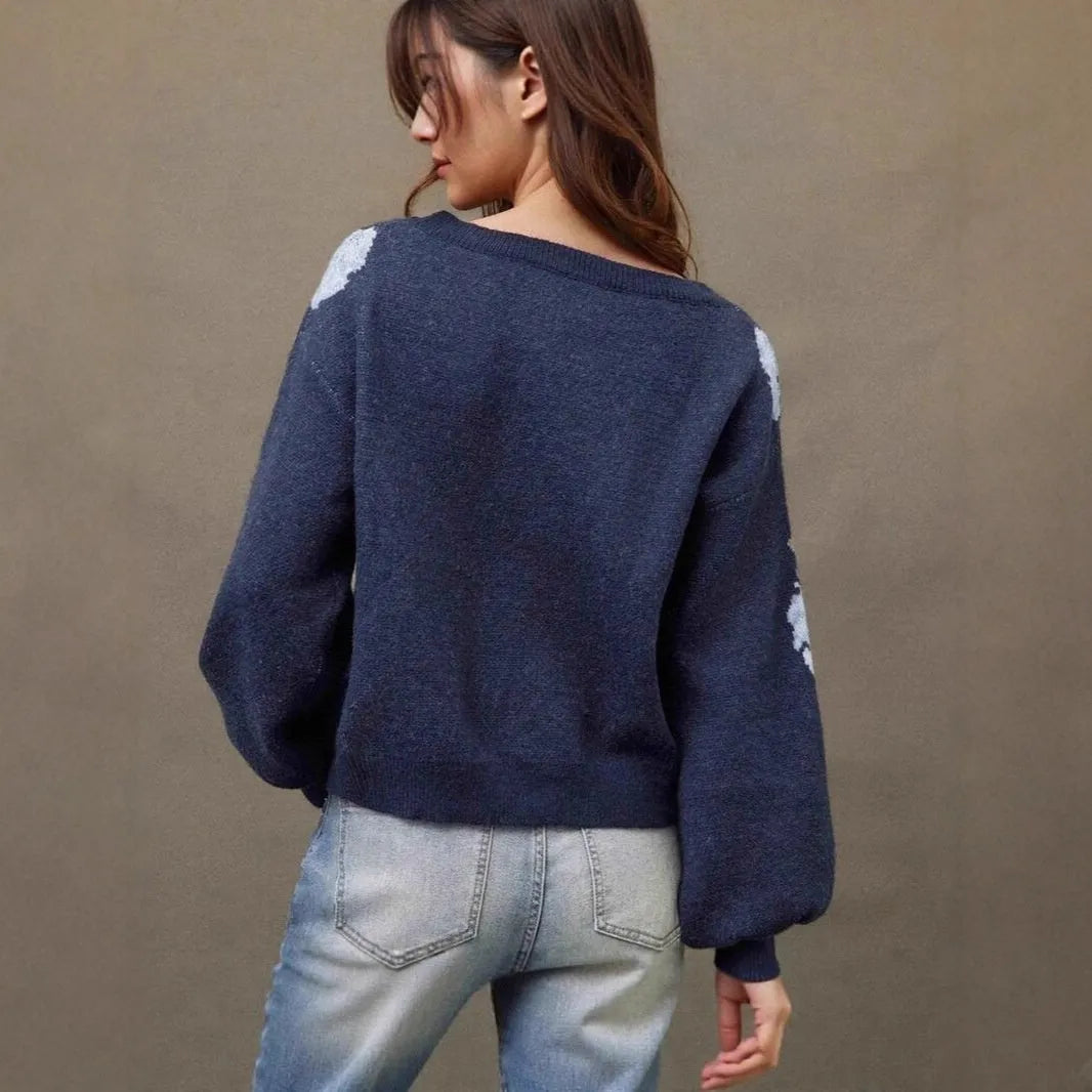 Sapphire blue women's loose pullover with a white floral jacquard pattern, off-neck design, and long sleeves.