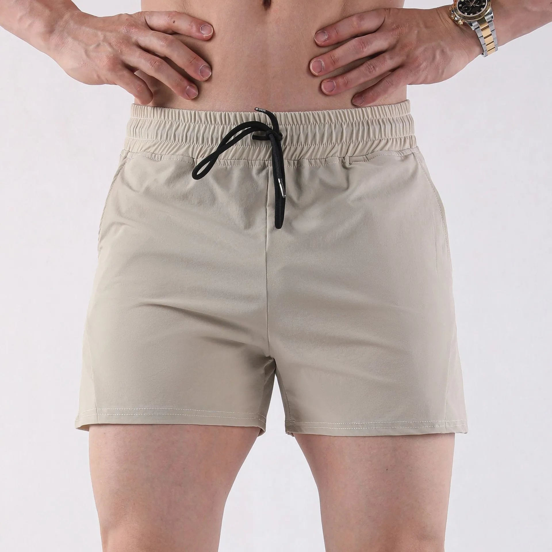 Men's thin grey polyester basketball shorts with elastic waistband, shown laid flat.