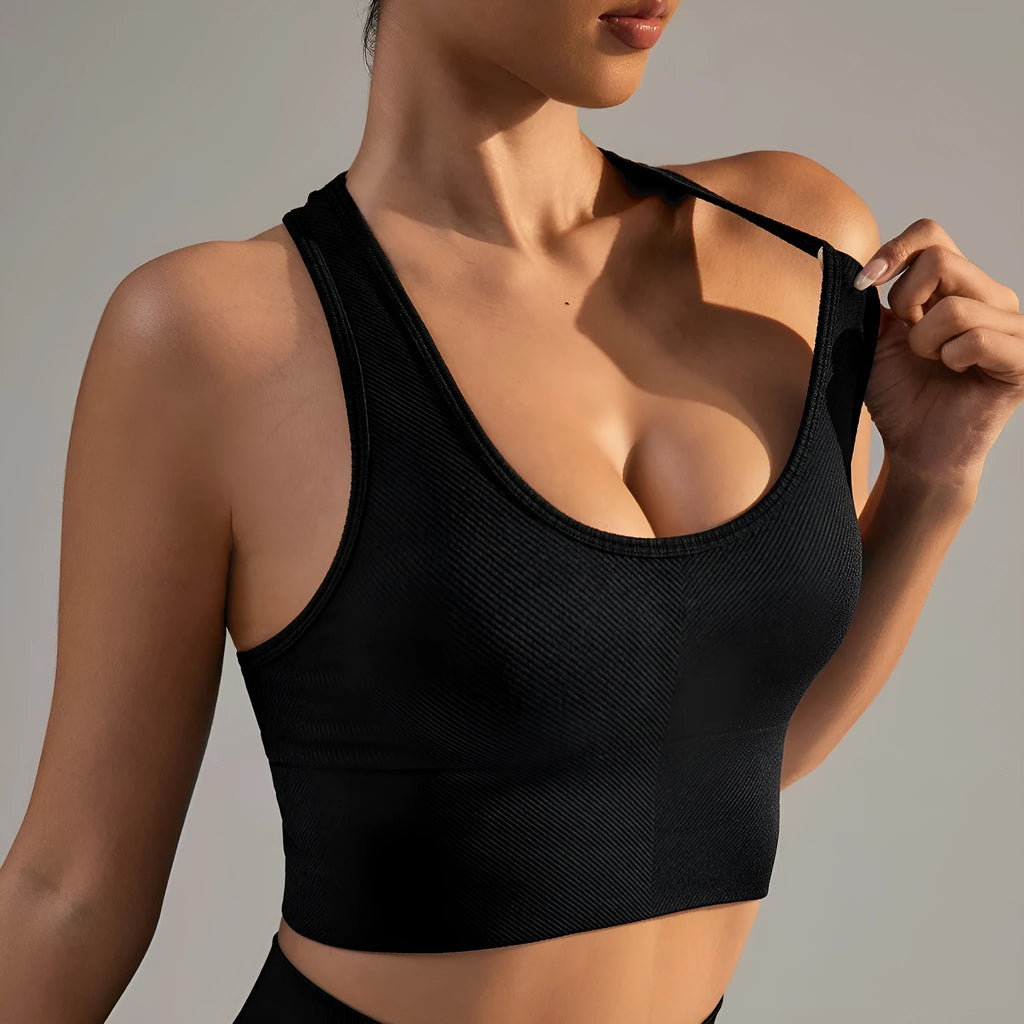 Black women's sports bra with cross back design and full cup support for athletic wear.