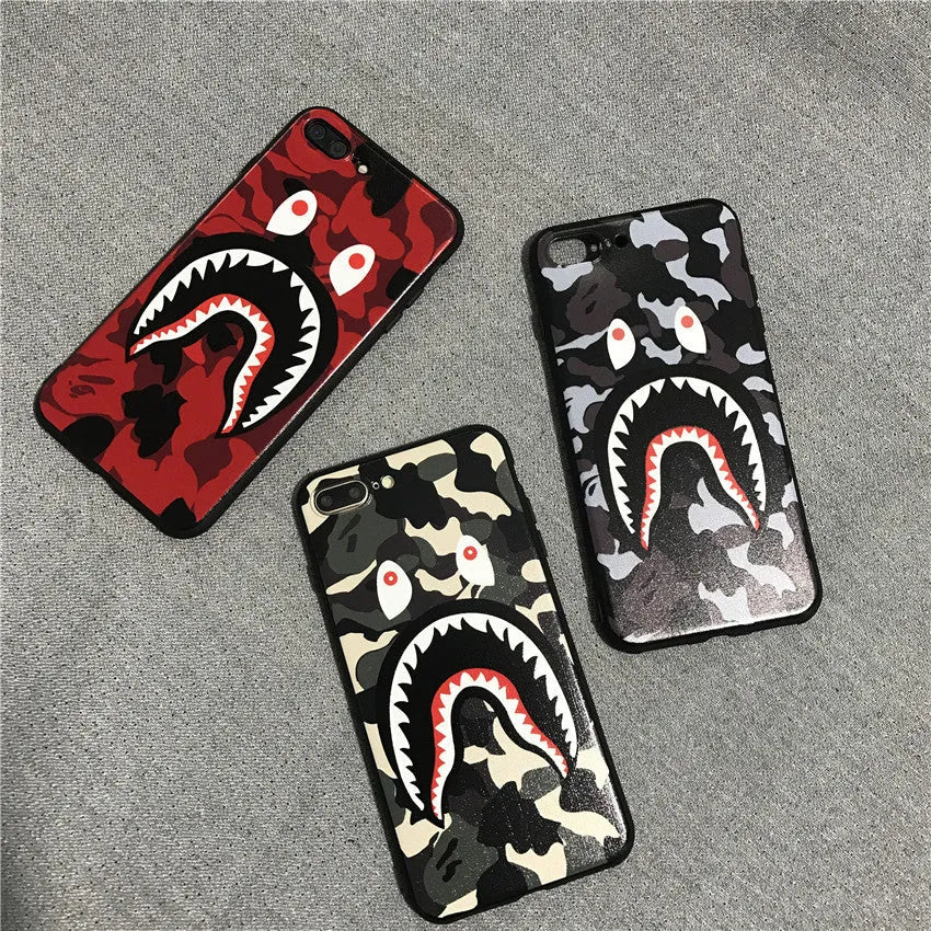 Frosted silicone phone case with shark mouth design in red, green, gray, and pink colours