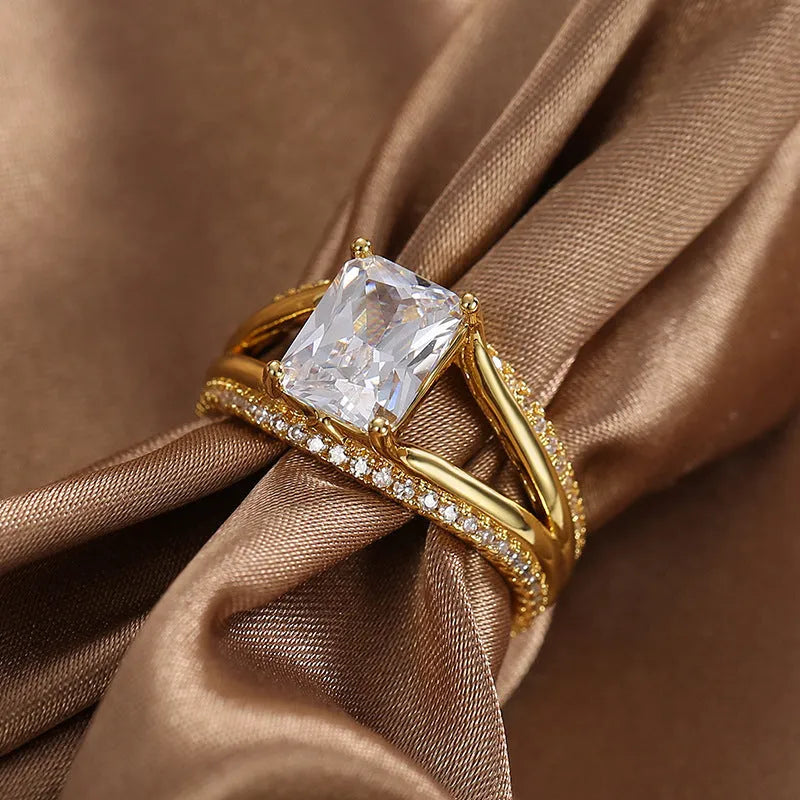 Gold-coloured geometric women's ring with a square zircon stone, shown in sizes 6 to 9.