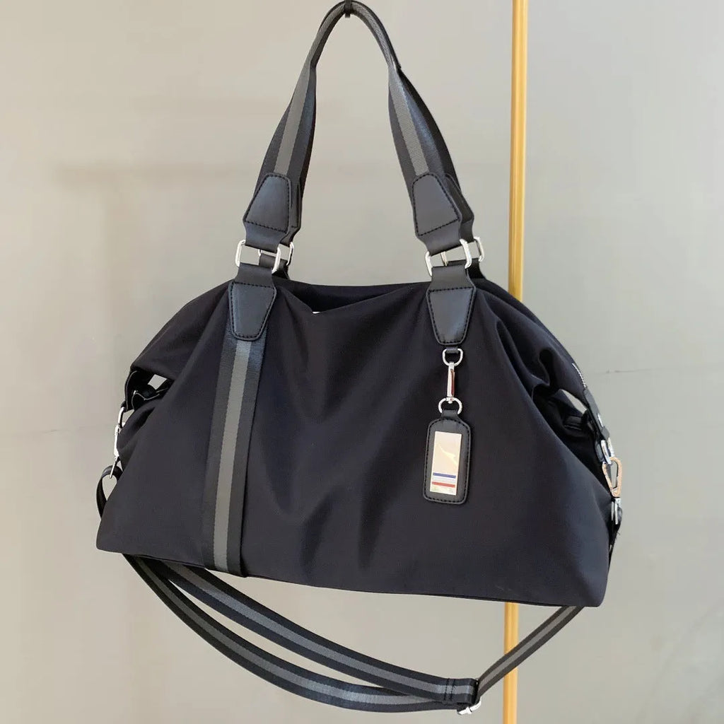 Black Gold Oxford cloth travel bag with zipper closure and three shoulder strap points on plain background