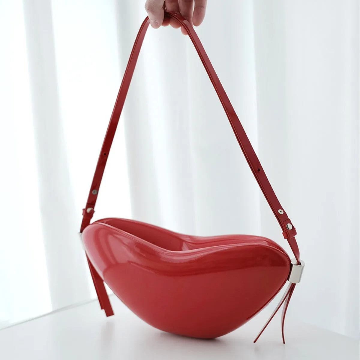 Red heart shaped crossbody bag in solid PU synthetic leather with single shoulder strap and sandwich pocket