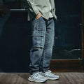 Men's blue loose straight-leg denim trousers with a zip fly placket laid flat.