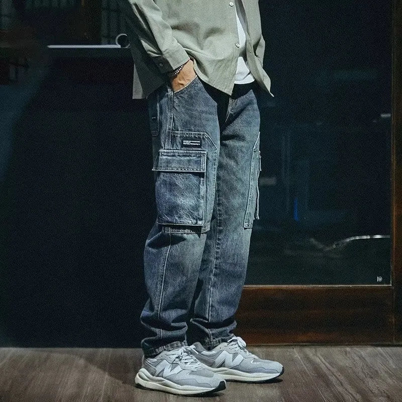 Men's blue loose straight-leg denim trousers with a zip fly placket laid flat.