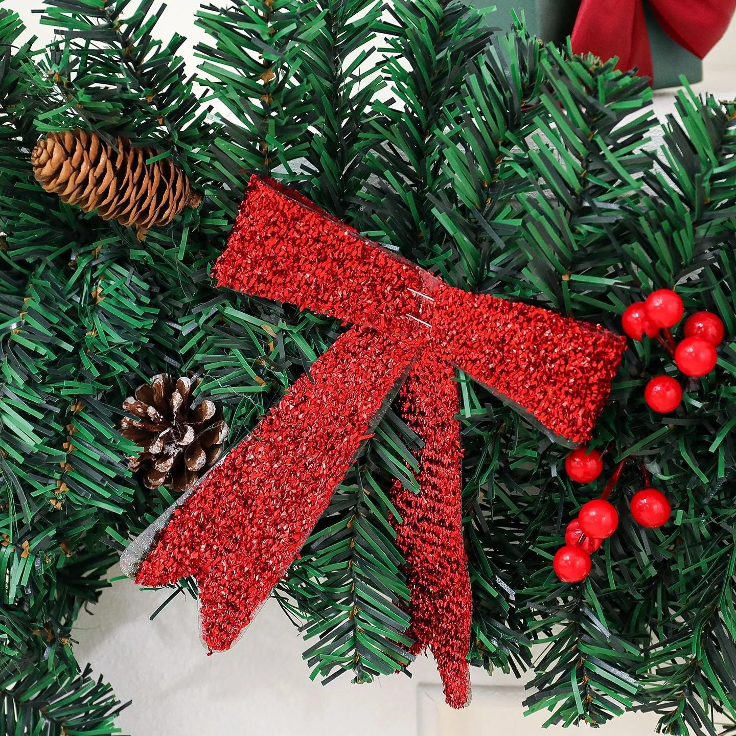A modern European-style rattan Christmas cane decoration with a pine cone bow, available with different light options.
