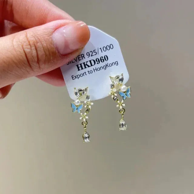 Geometric heart shaped women's ear clips with rhinestone stars and dangling tassel details