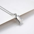 Silver curved peach heart pendant necklace on a stainless steel chain with extension.