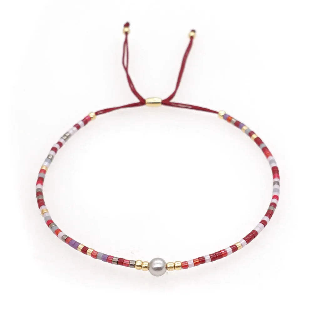 Handmade bohemian bracelet with colourful semi-precious stones and glass beads in geometric patterns.