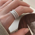 Women's geometric ring with woven twisted multilayer design and adjustable opening
