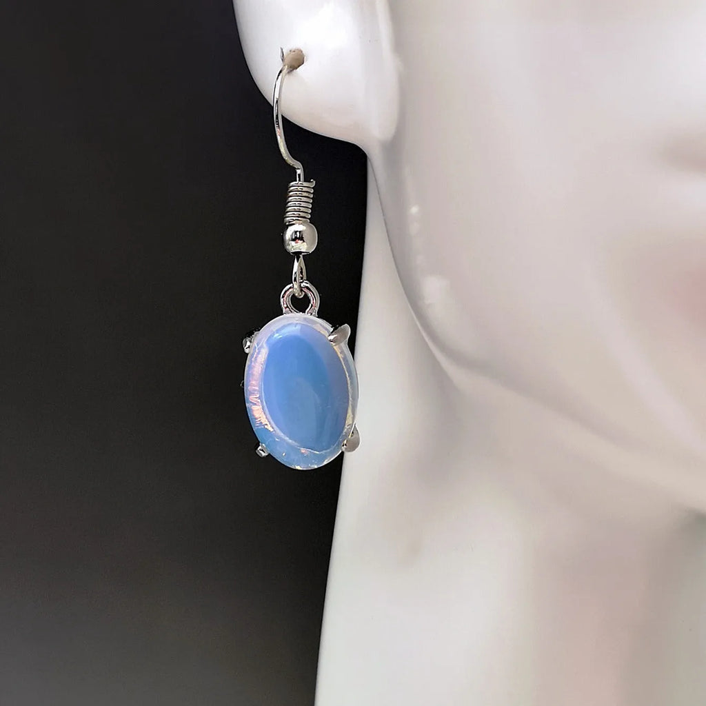 Opal earrings with retro moonstone aesthetic, cross design and ellipse pendant in drop shape