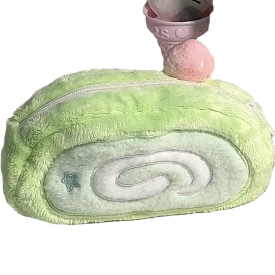 Soft velvet pencil case with Swiss roll cake design, rolled up.
