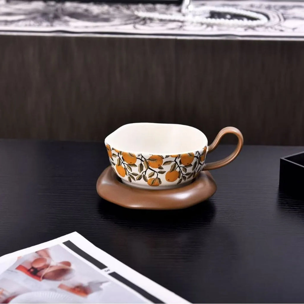 Antique style ceramic coffee cup and saucer set with medieval design in black or orange