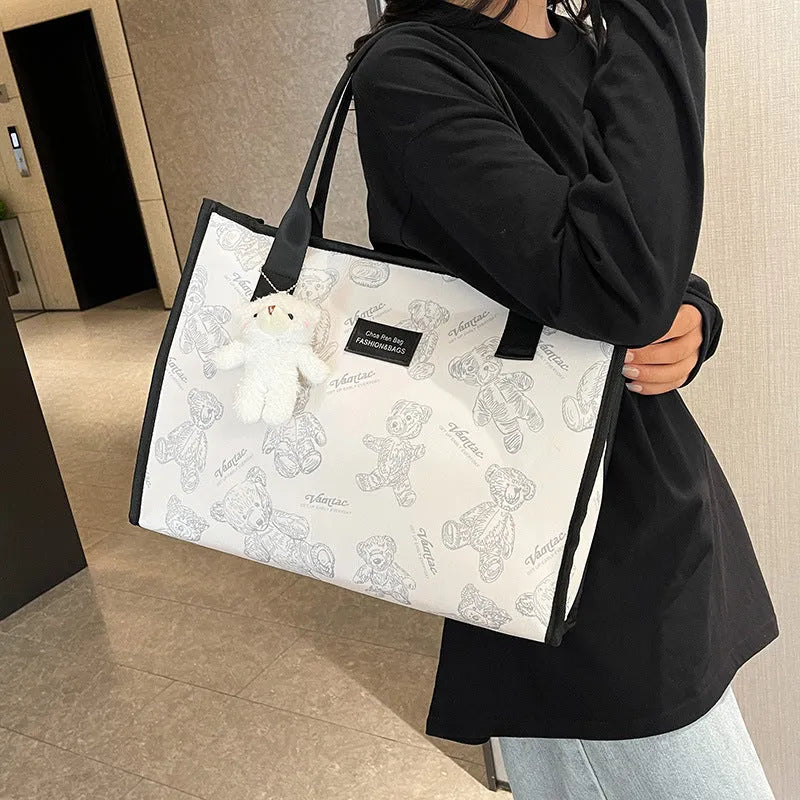 Women's black canvas tote bag with rhombus print pattern and shoulder strap